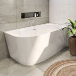Decina Natalia white back-to-wall corner bath in a tiled bathroom, with oval interior and integrated overflow visible