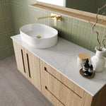 Marquis Gold wall hung vanity with natural oak finish, white basin and marble-look top in bathroom setting