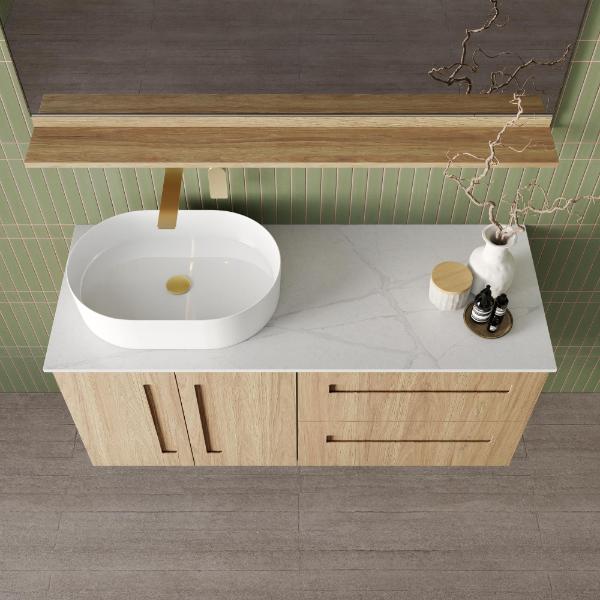 Marquis Gold wall hung vanity in natural oak with white above-counter basin, marble-look top and brass tap detail