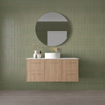 Marquis Hamilton wall hung vanity in light oak finish with white top and round basin in green-tiled bathroom