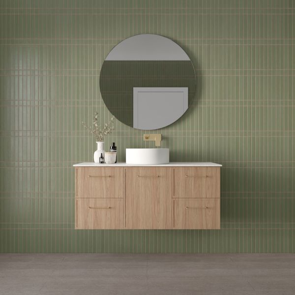 Marquis Hamilton wall hung vanity in light oak finish with white top and round basin in green-tiled bathroom
