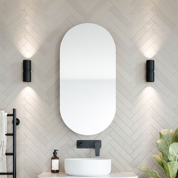 Ingrain Ash Pill shaving cabinet with oval mirror, wall mounted above basin in a modern bathroom setting