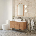Ingrain timber framed arch mirror in natural ash finish, wall-hung above vanity in a bathroom setting