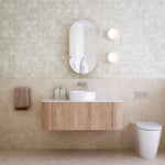 Ingrain curved fluted wall hung vanity in woodgrain finish with white top, shown in a bathroom setting