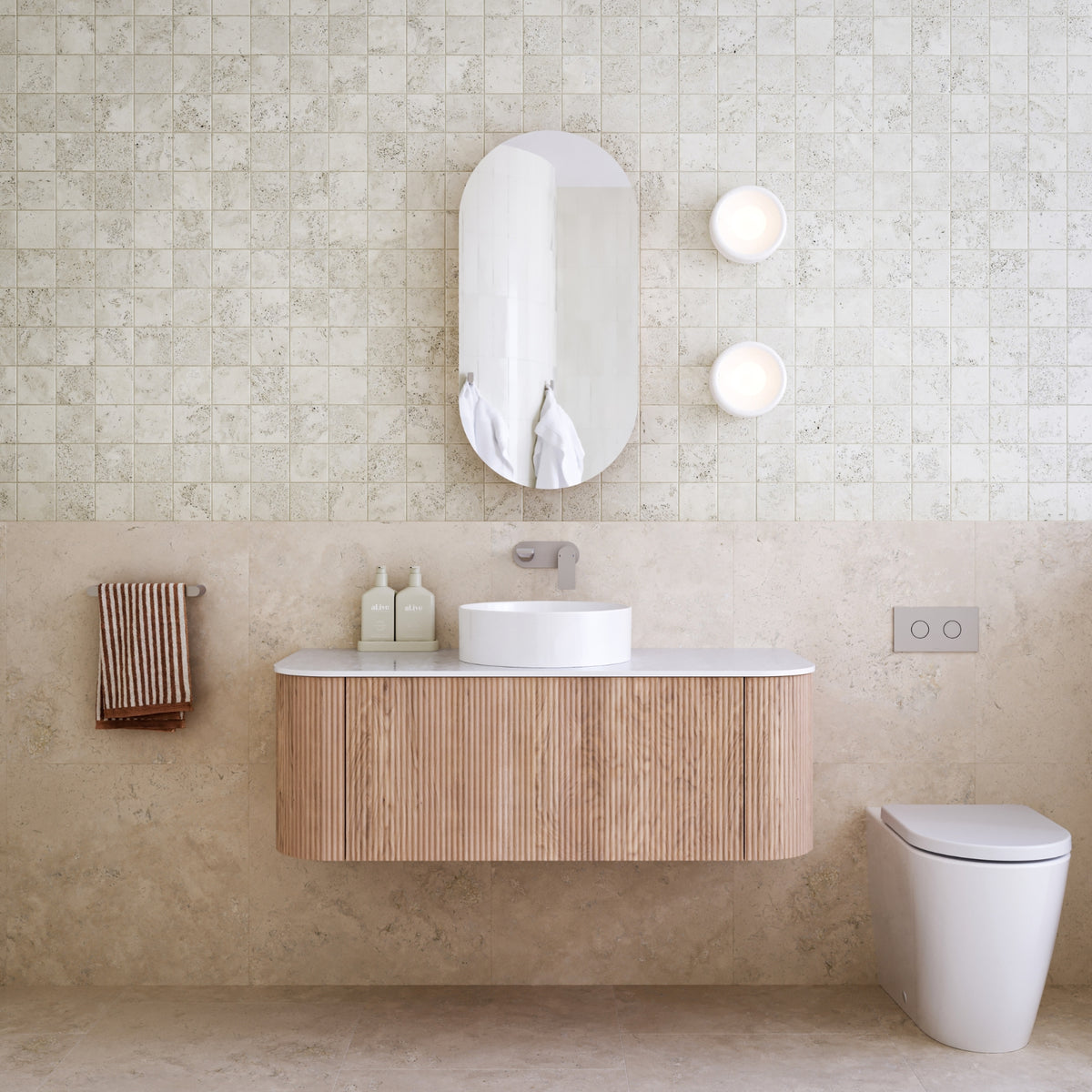 Ingrain curved fluted wall hung vanity in woodgrain finish with white top, shown in a bathroom setting