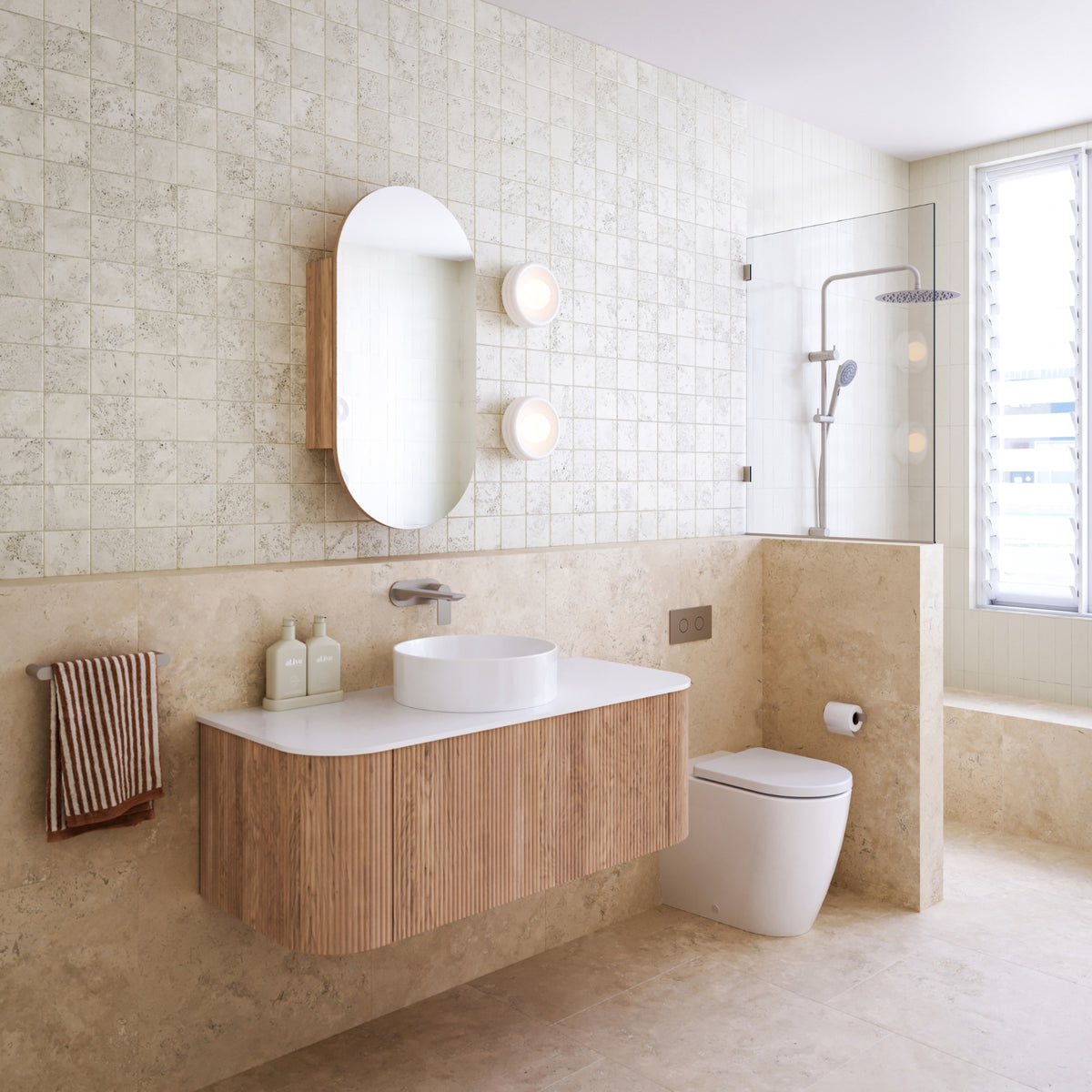Ingrain curved fluted wall hung vanity in woodgrain with white top and round basin in a contemporary bathroom