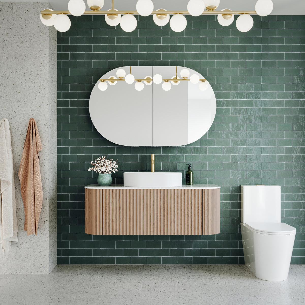 Ingrain Curved Fluted wall hung vanity in woodgrain, shown in a bathroom with white basin and green tiled wall
