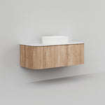 Ingrain curved wall hung vanity in woodgrain with white top, shown front on against a plain wall