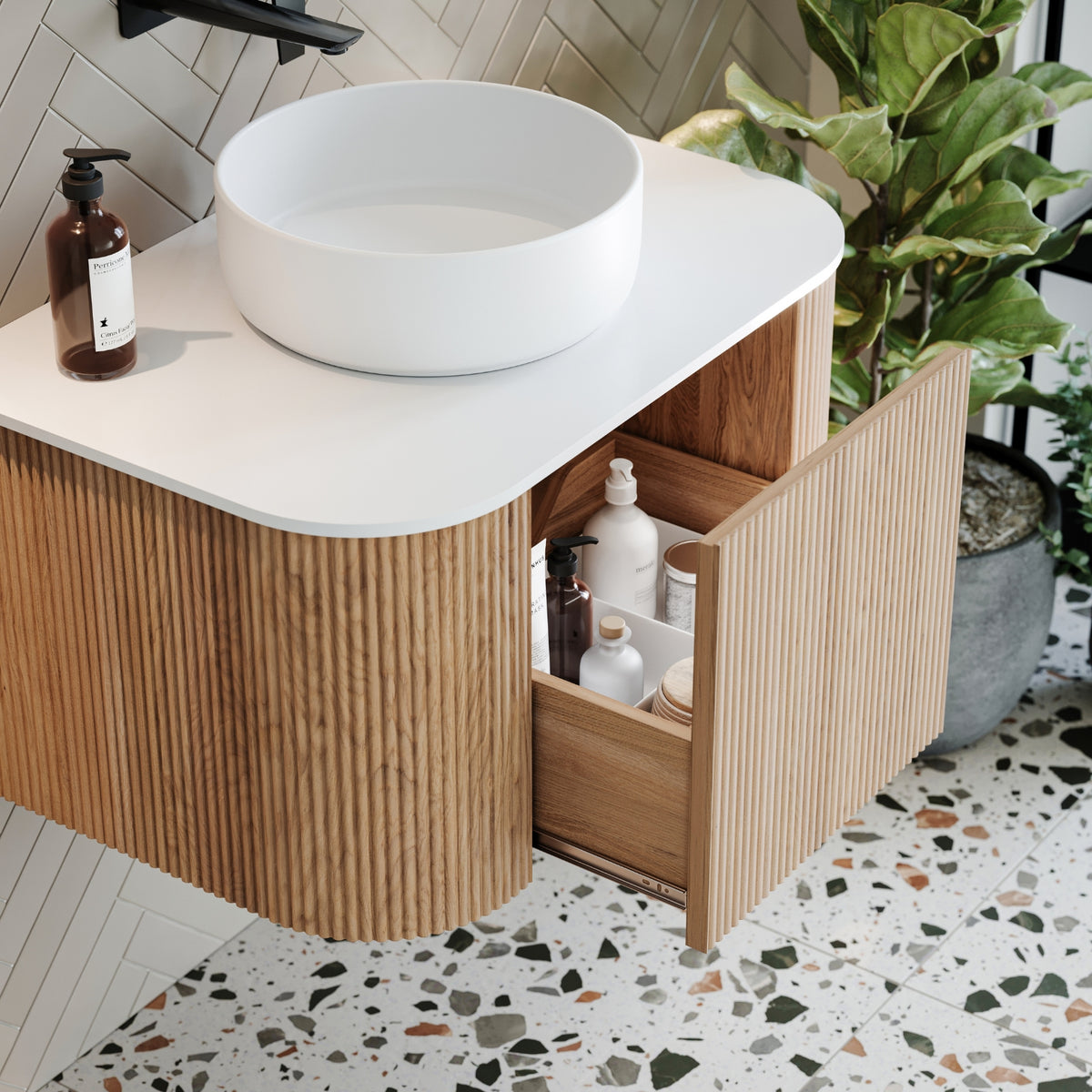 Ingrain curved fluted wall hung vanity with white top, open drawer and woodgrain finish in bathroom setting
