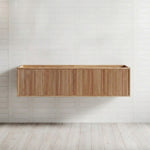 Ingrain Grooved wall hung vanity in warm ash woodgrain, with fluted drawer front, shown floating against white tiled wall.