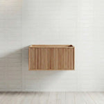 Ingrain Grooved wall-hung vanity in ash woodgrain, fluted front, mounted on a white tiled wall