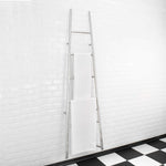 Thermogroup Jeeves Tangent L chrome heated towel rail, tapered ladder style with two white towels in bathroom setting