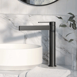 Phoenix Lexi MKII vessel mixer tap in matte black, tall basin mixer with slim spout beside a white vessel basin.