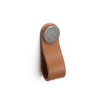ADP Loop leather cabinet pull in tan with round metal fixing, shown front on white background