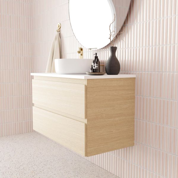 Marquis Marq wall hung vanity with two drawers, coastal oak finish and white top, shown in bathroom setting with round basin and mirror