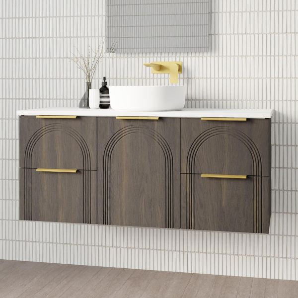 Marquis Arco wall hung vanity in prime oak with white benchtop, brushed brass handles and round basin in bathroom setting