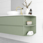 Marquis Avion wall hung vanity in sage green, with white top, basin and right-side curved open shelves in bathroom setting