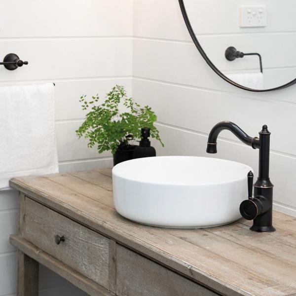 Phoenix Nostalgia basin mixer tap in antique black, with shepherds crook spout on a bathroom vanity basin