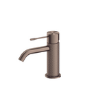 Nero Opal basin mixer tap in brushed bronze, with knurled cylindrical body and slim lever handle