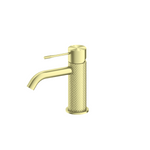 Nero Opal basin mixer in brushed gold with textured cylindrical body and curved spout, front view on white background