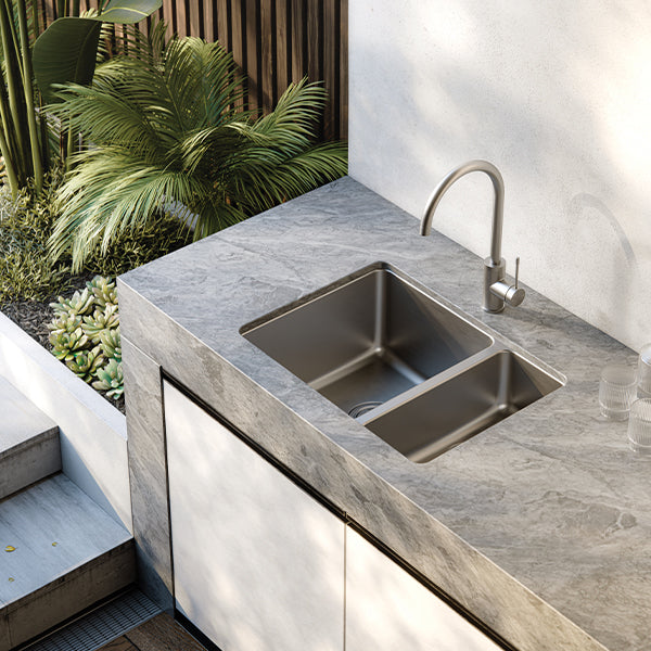 Phoenix 2000 Series stainless steel 1-1/2 bowl kitchen sink installed in grey benchtop with mixer tap