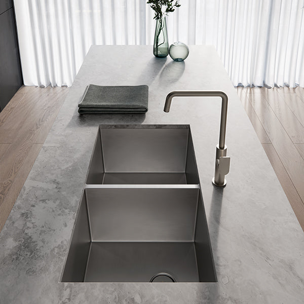 Phoenix 4000 Series brushed stainless steel double bowl kitchen sink in a concrete benchtop, undermount view with mixer tap