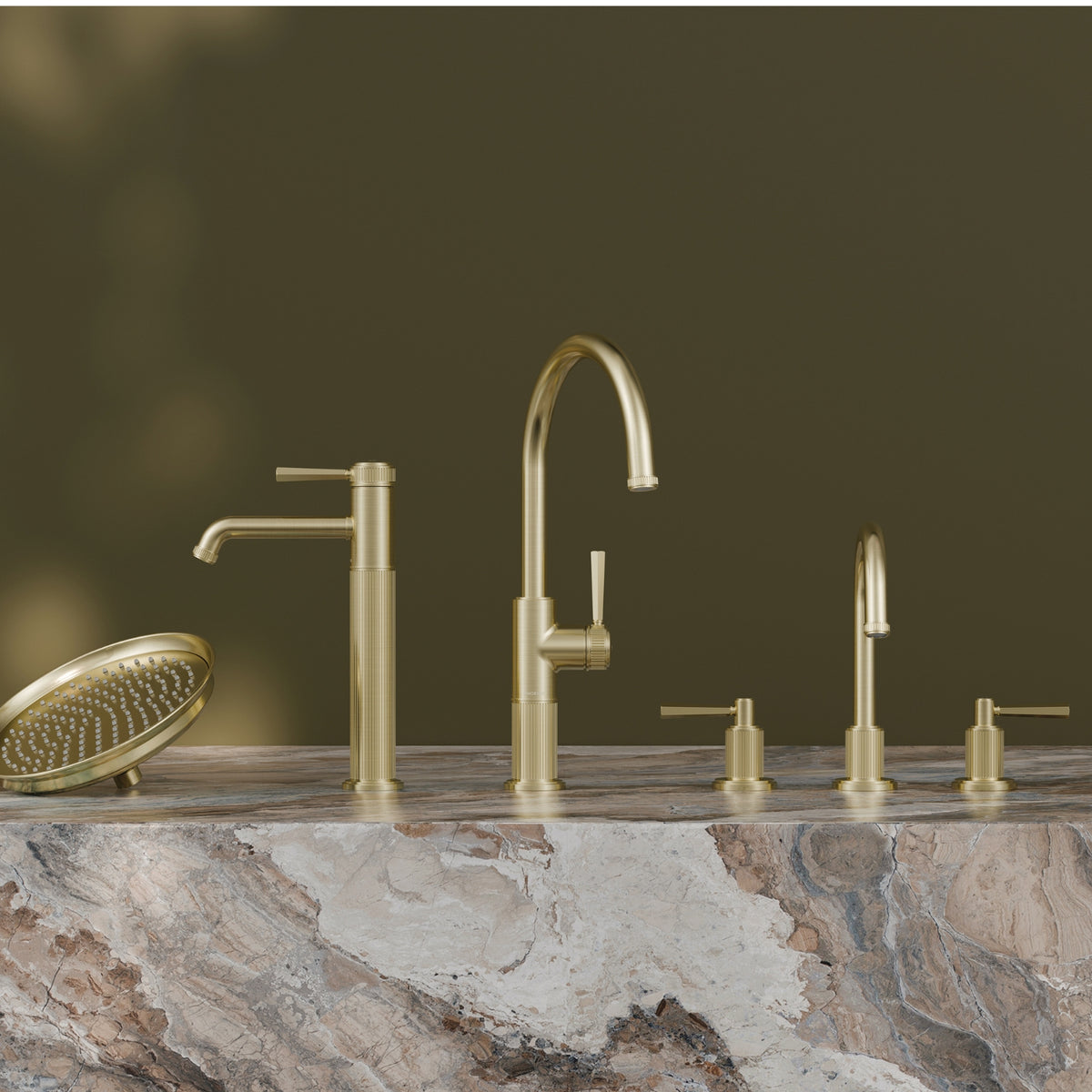 Phoenix Wiltern brushed gold vessel mixer range on a stone benchtop, featuring tall mixer tap and matching accessories