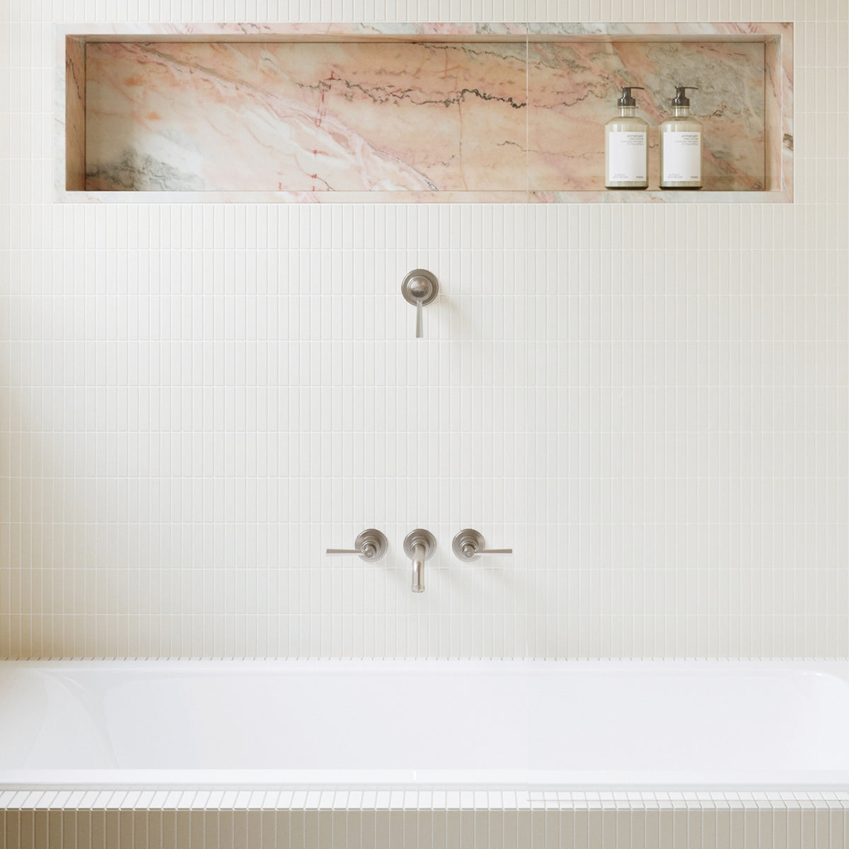 Phoenix Wiltern brushed nickel wall basin/bath outlet installed on a tiled bathroom wall above a bath