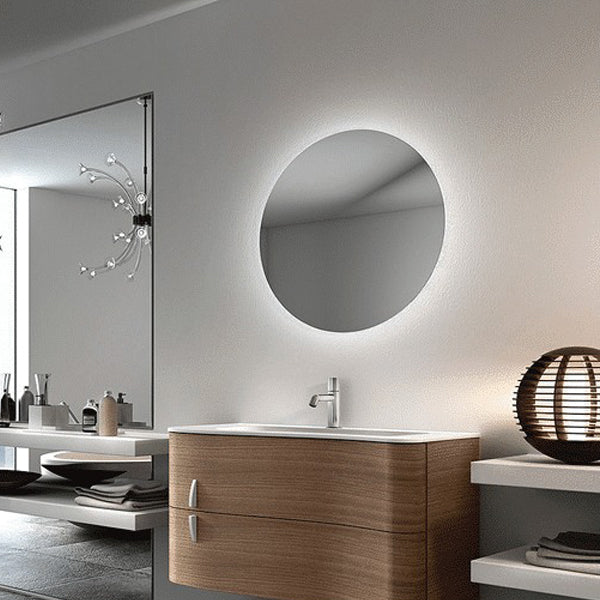 Thermogroup Ablaze round back-lit bathroom mirror on wall, warm LED glow around a 600mm silver mirror in a vanity setting