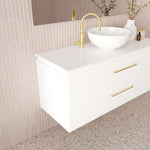 Marquis Riviera white wall hung vanity with drawers, white benchtop and brushed brass handles in bathroom setting