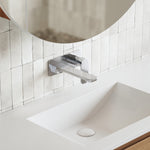 Caroma Luna wall basin mixer in chrome, mounted above a white basin in a modern bathroom setting