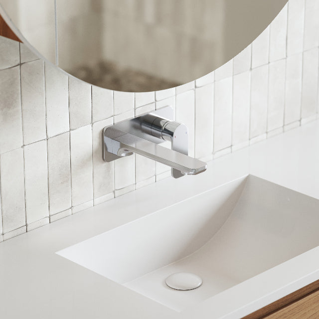 Caroma Luna wall basin mixer in chrome, mounted above a white basin in a modern bathroom setting