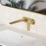 Caroma Contura II wall basin mixer in brushed brass, wall-mounted over a white basin with slim spout and lever handle
