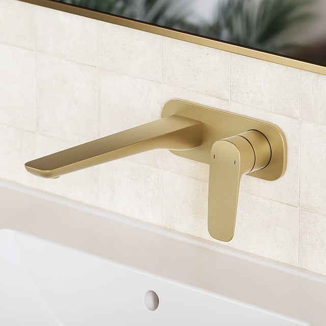 Caroma Contura II wall basin/bath mixer in brushed brass, shown mounted over a basin with long spout and single lever control