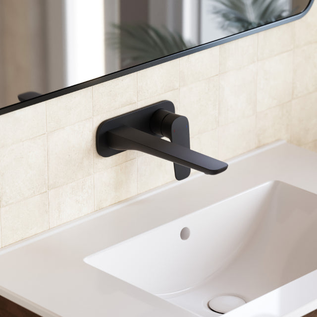 Caroma Contura II matte black wall basin/bath mixer with lever handle, shown installed over a white basin on tiled wall