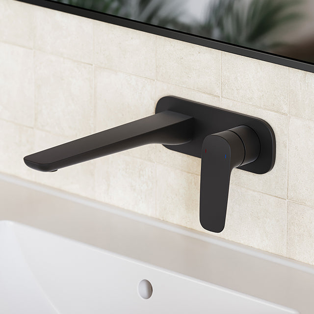 Caroma Contura II wall basin/bath mixer in matte black, wall-mounted with lever handle, shown above a bathroom basin.