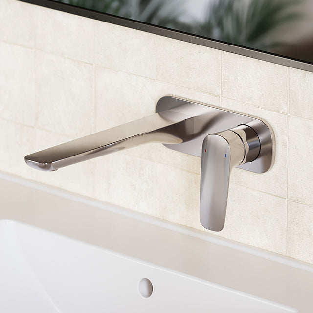 Caroma Contura II chrome wall basin/bath mixer with 180mm spout, shown installed above a bath or basin panel