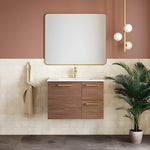 Caroma Contura II brushed brass basin mixer above a timber vanity and wall mirror in a modern bathroom.