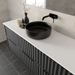 Marquis Salamander wall hung vanity with striped black drawers, white benchtop and black round basin, angled view