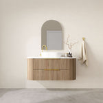 Marquis Shore wall hung vanity with fluted woodgrain drawers, white top and basin, brass handle, lifestyle view