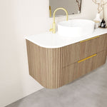 Marquis Shore wall hung vanity, woodgrain fluted drawers with white solid surface top and offset basin, angled view