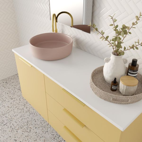 Marquis Shortland wall hung vanity with white solid surface top, pink basin and yellow drawers in a bathroom setting