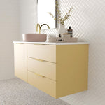Marquis Shortland wall hung vanity with white solid surface top, pink offset basin and brass handles in yellow finish