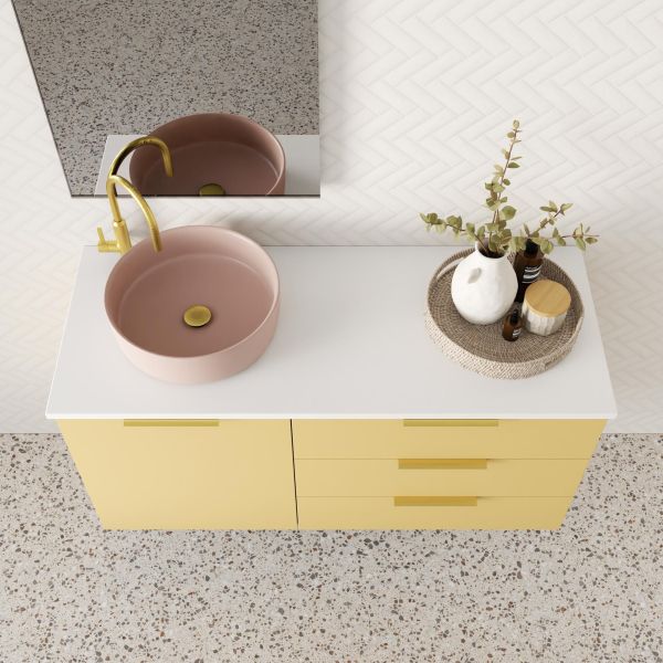 Marquis Shortland wall hung vanity with white solid surface top, pink basin and yellow drawers in bathroom setting