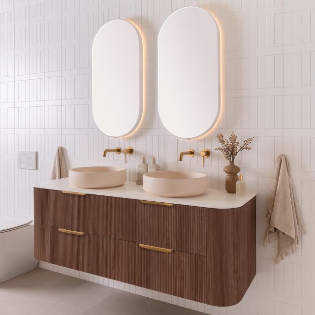 ADP Thirroul wall-hung vanity with curved wood finish, white benchtop and twin round basin in a modern bathroom setting