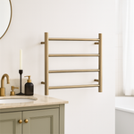 Thermogroup 4-bar heated towel ladder in brushed brass, wall-mounted in a bathroom beside a vanity and basin