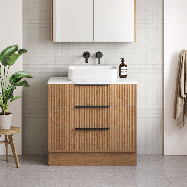 Timberline Emmett Apollo floor standing vanity with fluted woodgrain drawers, white above counter basin and black handles