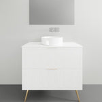 Timberline Sutherland House Deco white vanity with oval basin, fluted drawer fronts and brass legs in bathroom setting