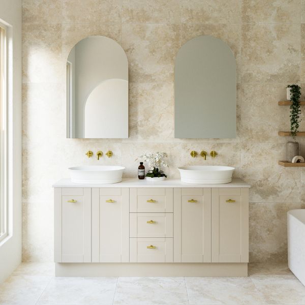 Timberline Victoria floor standing vanity in soft beige with double above basins, brass handles and Silksurface top in a bathroom setting