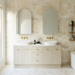 Timberline Victoria floor standing vanity in soft beige with double above basins, brass handles and Silksurface top in a bathroom setting